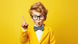little boy with wearing glasses on yellow background