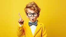 Little Boy With Wearing Glasses On Yellow Background
