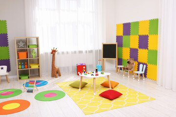 Sticker - Child`s playroom with different toys and furniture. Cozy kindergarten interior