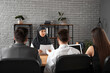 © Pixel-Shot - Human resources commission interviewing Muslim applicant in office
