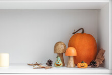 Halloween Pumpkins With Mushrooms, Fir Cones And Fallen Leaves On Shelf In Kitchen