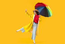 Stylish Young Asian Woman In Fall Clothes With Umbrella On Yellow Background