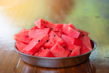 Wall Mural - Slices of watermelon in aluminum bowl on wooden table