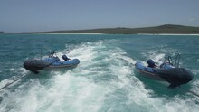 Small Blue Rubber Zodiac, Or Tender Dingy, Being Dragged Through The Turquoise Water The Pacific Ocean Of The Galapagos Islands.