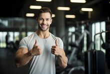Young Man After Successful Workout Posing In Modern Fitness Gym While Showing Thumb Up