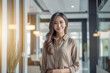© Surachetsh - In the backdrop of a blurred office, a confident and intelligent young Asian woman, elegantly attired in a light gray suit paired with a crisp white shirt, delivers a presentation. Generative AI.