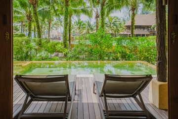 Wall Mural - living room Interior of a modern house with a swimming pool, modern pool villa at the beach, indoor view of a luxury villa in Thailand