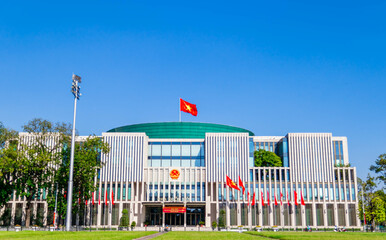 National Assembly Building of Vietnam with blue sky background and its green courtyard at the center of Ba Dinh square near Ho Chi Minh mausoleum.