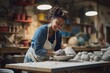 © Darya - Beautiful african woman holding pottery instrument for scraping, smoothing, shaping and sculpting. Lady siting on bench with pottery wheel and making clay pot (generative ai)
