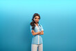 © overrust - Cute cartoon nurse with folded arms isolated on blue background