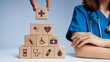 Concept of Insurance for your health, Hand hold wooden block with icon healthcare medical