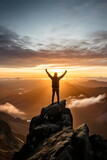Fototapeta Fototapety góry  - person standing on top of mountain peak celebrating holding up arms looking at sunrise or sunset, success