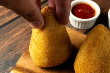 Wall Mural - two traditional Brazilian coxinhas. typical fried snack food stuffed with meat and chicken