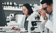 © Talia Mdlungu/peopleimages.com - Science, team in research and man with microscope in laboratory, data for drugs or medical innovation. Healthcare, biotech lab analytics and medicine, scientist collaboration in pharmaceutical study.