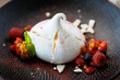 Pavlova berry cake with passion cream, strawberry, meringue. Delicious sweet dessert food closeup served for lunch in modern gourmet cuisine restaurant