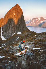 man hiking alone in norway mountains travel with backpack outdoor active vacations healthy lifestyle