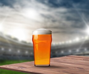 Wall Mural - Glass of fresh cold alcohol beer on stadium background