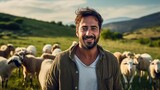 Fototapeta  - Portrait of a smiling young shepherd man, herding a flock of sheep.