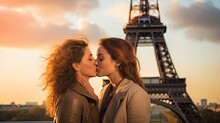 Couple Of Two Young Women Kissing On The Lips, Eiffel Tower From Paris On Background.
