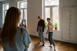 © DimaBerlin - Family of three mother and two kids making social media content video on smartphone, modern young mother recording children bloggers dancing in front of phone at home. Blogging and small children