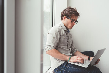 young caucasian man indoor using computer