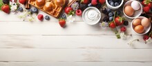 Top View Of Easter Breakfast With Quail Eggs Waffles Fruit Jam Milk And Sandwiches On A White Wooden Background With A Willow Branch And Room For Text
