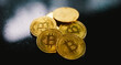 Golden coins with a bitcoin symbol and black background