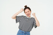 © Mix and Match Studio - Image of excited young girl cheering, raising hands up, screams from excitement and happiness, winning, celebrating victory, standing over white background