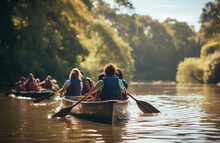 Group Of Colleagues Enjoying Canoe Down On A Peaceful River.