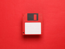 Red Floppy Disk On A Red Background. Retro 80s