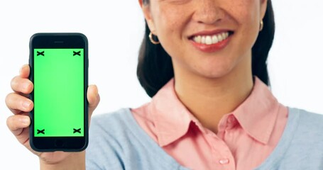 Sticker - Happy woman, phone and hands with green screen in advertising or marketing against a studio background. Closeup of female person showing mobile smartphone app, mockup or display with tracking markers