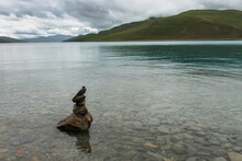 Cairn Sitting In The Shallow Water Along The Shoreline Of Sacred Lake; Shannan Xizang China