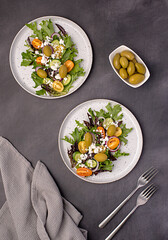 Wall Mural - Food photography of salad; cheese manouri, feta; vegetable; tomato; cucumber; onion; lettuce; sauce; pepper; olive; seasoning