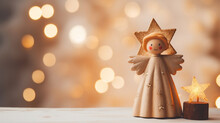 Wood Figurine Of An Christmas Angel In Front Of An Bokeh Background