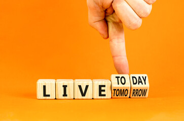 Wall Mural - Live today not tomorrow symbol. Businessman turns wooden cubes and changes word Live tomorrow to Live today. Beautiful orange background. Business and live today not tomorrow concept. Copy space.