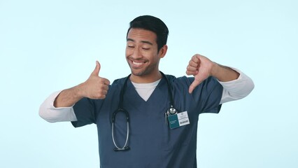 Sticker - Thumbs up, medical decision and confused Asian man with hands gesture for choice, option and doubt. Healthcare, studio and portrait of health worker unsure for clinic service on blue background