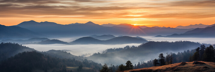 Canvas Print - panorama, sun rising over a mountain range, valleys filled with mist, vibrant sky transitioning from