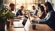 © visoot - Group of business people sitting behind a desk working with laptops in modern office.