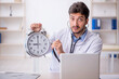 © Elnur - Young male doctor in time management concept