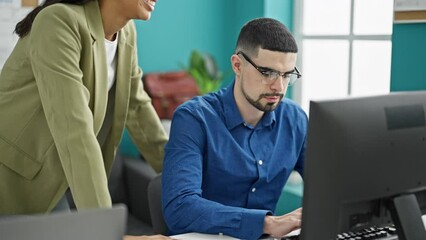 Canvas Print - Two office workers, man and woman, embrace technology at work