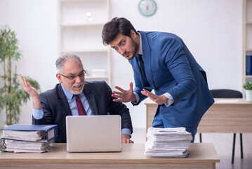 Wall Mural - Two male colleagues working in the office