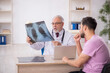 © Elnur - Young male patient visiting old male doctor radiologist