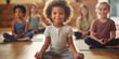 Group diverse little girls sitting in lotus position meditating during session at yoga studio. Girls practicing exercises visualizing calming the brain increasing awareness and attentiveness