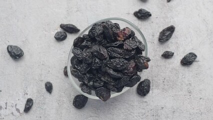 Wall Mural - black raisin on white background, close up,