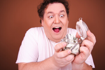 Wall Mural - Funny fat man posing in the studio. Brown background.