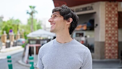 Poster - Young hispanic man smiling confident standing at street