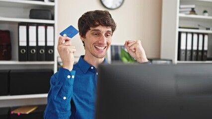 Poster - Young hispanic man business worker shopping with computer and credit card with winner gesture at the office