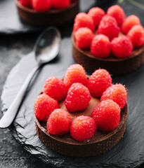 Wall Mural - Chocolate cakes with raspberry close up