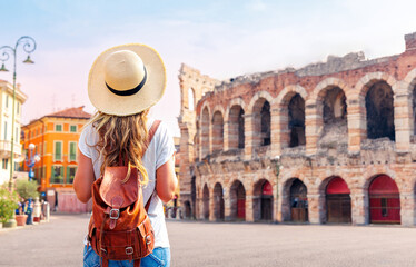 Wall Mural - Traveler girl with hat and bag looking at Verona Arena,  tour tourism, travel,vacation in Italy- travel in Europe