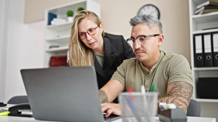 Poster - Man and woman business workers working together using laptop at the office